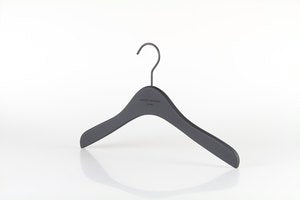 A single black Wooden Rubber Soft Touch Kids Top Harvey Nichols 32cm hanger from Rustic Motifs with a curved design is shown against a plain white background. The hanger has a metal hook at the top and a smooth, minimalist appearance.