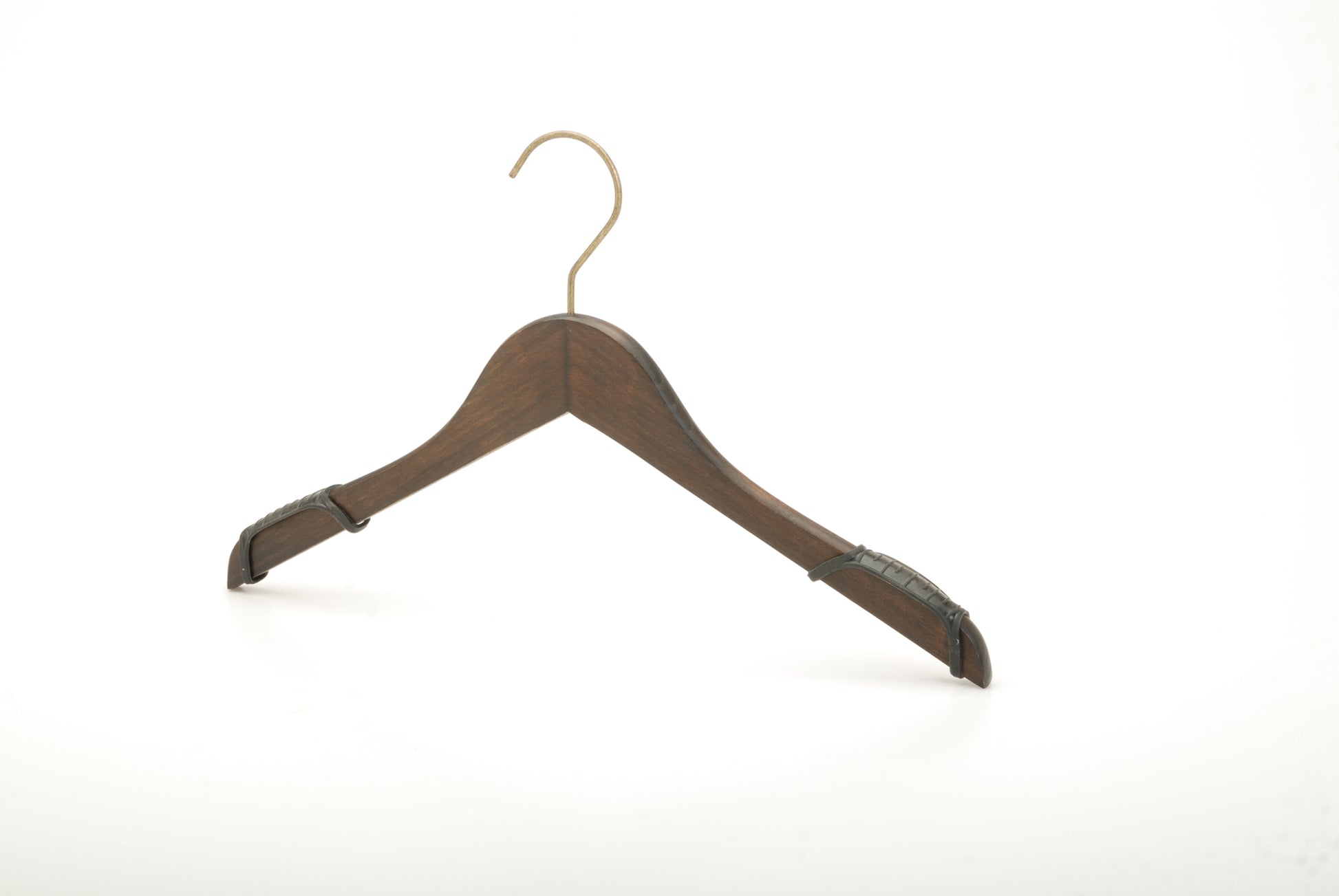 A wooden coat hanger with a brass hook is shown against a plain white background. The Rustic Motifs Wooden Antique finish Top 38cm, featuring an antique finish, has curved ends to support the shoulders of garments and black non-slip grips on the sides, adding a touch of vintage charm.