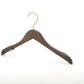 A wooden coat hanger with a brass hook is shown against a plain white background. The Rustic Motifs Wooden Antique finish Top 38cm, featuring an antique finish, has curved ends to support the shoulders of garments and black non-slip grips on the sides, adding a touch of vintage charm.