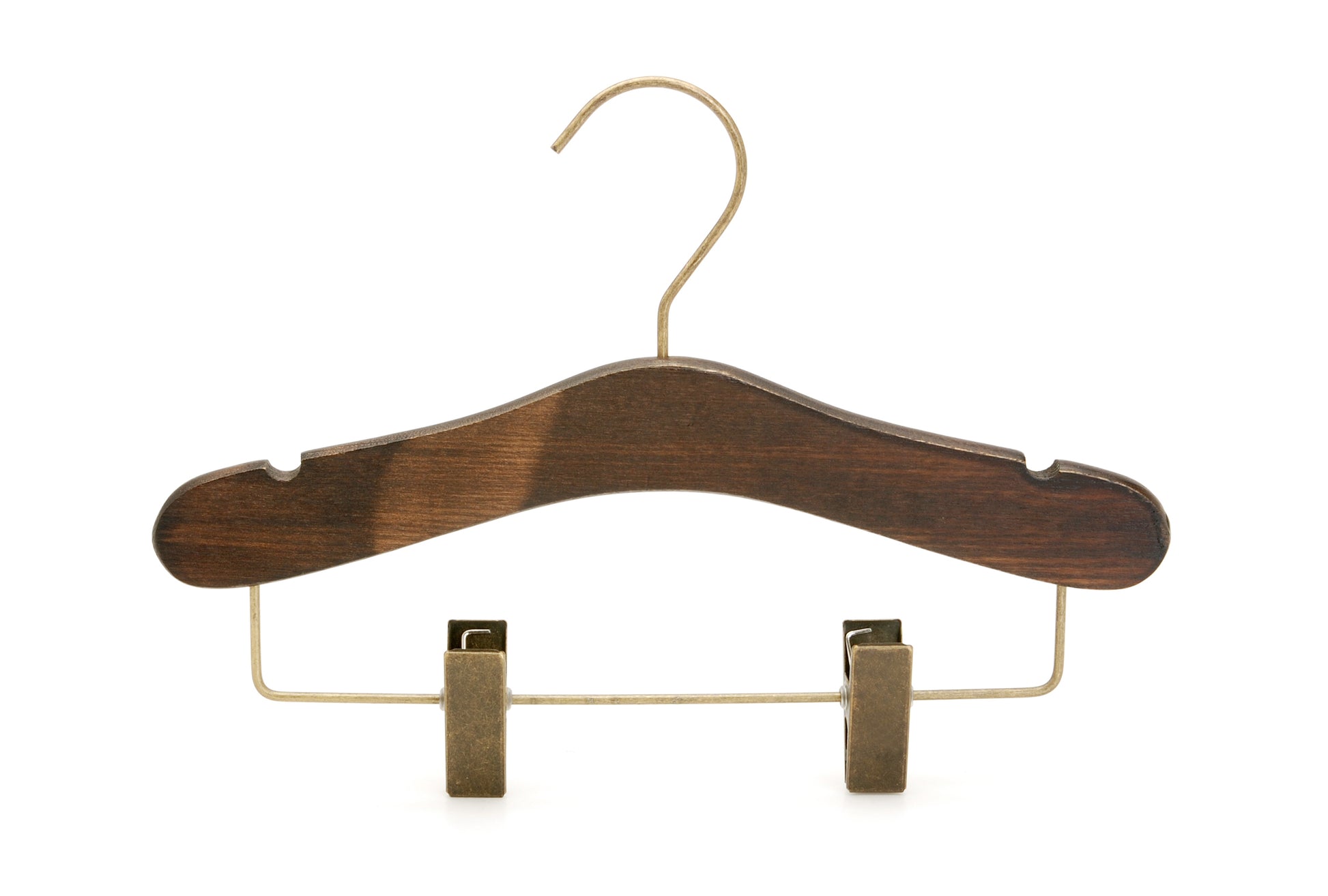 A dark brown wooden clothes hanger made from dark ash wood with a shiny metallic hook and two brass-colored metal clips on the bottom, designed for hanging pants or skirts. The Rustic Motifs Wooden Antique Kids Top Clip (Brass Hook) 28cm features a smooth, rounded shape.