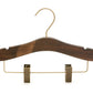 A dark brown wooden clothes hanger made from dark ash wood with a shiny metallic hook and two brass-colored metal clips on the bottom, designed for hanging pants or skirts. The Rustic Motifs Wooden Antique Kids Top Clip (Brass Hook) 28cm features a smooth, rounded shape.