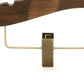Close-up image of a Rustic Motifs Wooden Antique Kids Top Clip (Brass Hook) 28cm made from dark ash wood with metal clips. The hanger features a dark brown finish and a curved design at the top, with metal clasps attached to the bottom for securing garments. The background is plain and white.