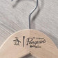 A Rustic Motifs Wooden Natural Top Branded Penguin 43cm with a metal hook features a logo that includes a penguin illustration and the text "an original Penguin by Munsingwear," resting on a textured light gray wooden surface.
