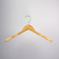 A Rustic Motifs Bamboo Wood Sustainable Top Jacket Hanger 42cm with a metallic hook is suspended against a plain gray background. The hanger is simple in design, featuring a natural wood finish with smoothly curved shoulders, offering an eco-friendly clothing organization solution.