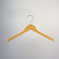 A Rustic Motifs Bamboo Wood Sustainable Top Hanger with Notch 42cm is elegantly suspended against a plain white background. The hanger features a metal hook at the top and notches on each end for securing garments with straps.