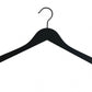 A Rustic Motifs Black Wooden Top Clothes Hanger with Notch 38cm, with a curved top, a metal hook at the center, and notches on each side for securing clothing is positioned against a white background.
