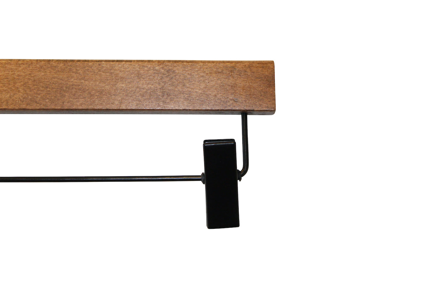 An image of a black metal clip attached to an FSC certified wooden hanger bar. The clip, designed to hold items such as pants or skirts, is aligned perpendicular to the sustainable dark wood hanger from Rustic Motifs. This specific product is the Dark Wood Sustainable Bottom Trouser Skirt Hanger With Clips 37cm. The background is plain white.