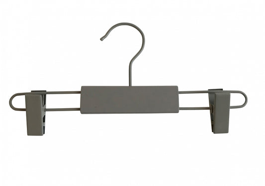 A Grey Wooden Kids Clip Bottom Hanger 26cm from Rustic Motifs featuring a hook at the top and two adjustable clips on each end, perfect for hanging children's pants or skirts. The central bar is covered with gray, rectangular padding. Made from eco-friendly wood, this hanger is set against a plain white background.