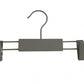 A Grey Wooden Kids Clip Bottom Hanger 26cm from Rustic Motifs featuring a hook at the top and two adjustable clips on each end, perfect for hanging children's pants or skirts. The central bar is covered with gray, rectangular padding. Made from eco-friendly wood, this hanger is set against a plain white background.