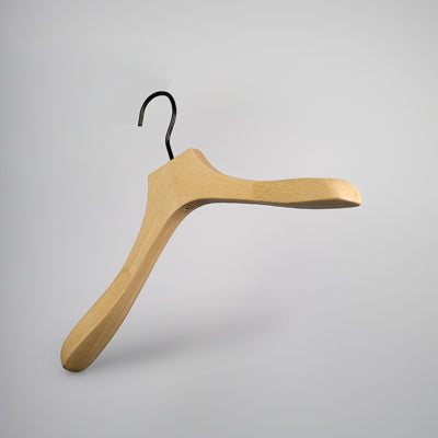 A Premium Natural Wooden Top Jacket Hanger 37cm by Rustic Motifs with broad, curved shoulders and a black metal hook is suspended against a plain white background. The minimalist design of this natural wooden top jacket hanger suggests a focus on functionality and aesthetics.