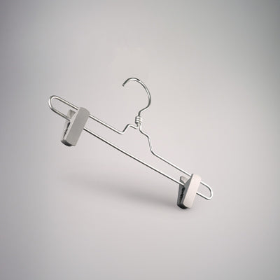 A Rustic Motifs Natural Aluminium Clip Bottom Hanger 35cm is suspended against a neutral gray background. The aluminium hanger has a simple, sleek design with a curved hook at the top for hanging, and the clip bottom design ensures secure garment holding at either end.
