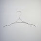 A Natural Aluminium Top Notch Coat Hanger 40cm from Rustic Motifs against a plain grey background. The hanger features a typical hook and shoulder design with slight bends near the ends to help secure clothing, making it an essential tool for wardrobe organization.