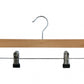 The Rustic Motifs Natural Wooden Clip Bottom Hanger 35cm is shown. This empty hanger boasts a metal hook for hanging and two adjustable metal clips with black grips at the bottom, perfect for wardrobe organization.
