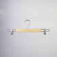 A Rustic Motifs Natural Wooden Clip Bottom Hanger 37cm with metal clips and a hook is suspended against a plain, light gray background. Made from sustainable solid wood, this high-quality hanger has a simple design, suitable for hanging pants or skirts.