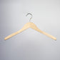 A durable wooden hanger with a metal hook is suspended against a plain, light gray background. The Rustic Motifs Natural Wooden Jacket Top Coat Hanger 44cm boasts a smooth finish and natural wood color, forming an inverted V shape with slightly curved arms, ideal for garment care.