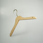 A Natural Wooden Thick Top Jacket and Bridal Hanger 39cm by Rustic Motifs is seen against a plain light gray background. The bridal notch hanger boasts a metal hook at the top for hanging and a smooth, straight bar for holding clothing. The design is simple and functional, embodying sustainability.