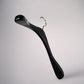 A sleek, modern Black Wooden Top Coat Premium Hanger 42cm from Rustic Motifs with a metallic hook is set against a plain, light gray background. Crafted from high-quality black wood, the hanger features an elegant curve design and a nonslip grip, blending functionality with a minimalist aesthetic.