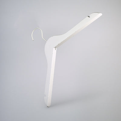 A White Wooden Clothes Hanger with Notch 44cm by Rustic Motifs with a simple, minimalist design is shown against a plain grey background. The high-quality clothes hanger has a hook at the top for hanging on a rod and is slightly angled to display its form clearly, perfect for closet organization.