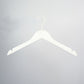 A high-quality, **White Wooden Clothes Hanger with Notch 44cm** by **Rustic Motifs** with a curved hook at the top and notches on either side for securing garments. Perfect for closet organization, it’s set against a plain light gray background.