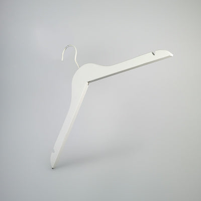 A Rustic Motifs White Wooden Clothes Hanger with Notch 38cm, positioned against a plain gray background, exemplifies closet organization. The hanger features notches on each shoulder for securing straps.