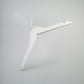 A Rustic Motifs White Wooden Clothes Hanger with Notch 38cm, positioned against a plain gray background, exemplifies closet organization. The hanger features notches on each shoulder for securing straps.