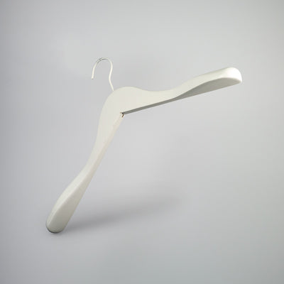 A white wooden jacket top coat hanger 44cm from Rustic Motifs is isolated against a plain gray background. Mimicking the style of a White Wooden Jacket Top Coat Hanger 44cm, it has a broad, contoured shape designed to maintain the structure of garments.