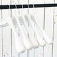 A row of five Rustic Motifs White Wooden Jacket Top Coat Hanger 44cm hanging on a black rod against a white wooden plank wall. The durable wood hangers are evenly spaced and uniformly aligned, creating a minimalist and orderly appearance.