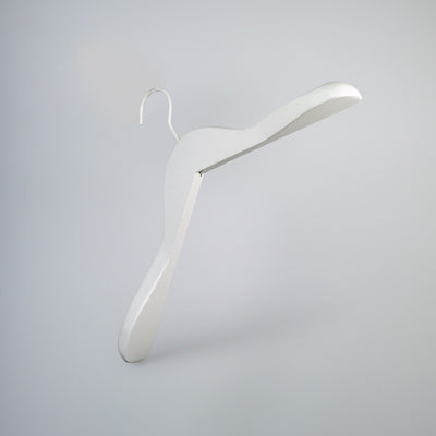 A minimalist, Rustic Motifs White Wooden Jacket Top Coat Hanger 38cm with a sleek, modern design hangs against a plain, light gray background. Ideal for wardrobe organization, this hanger features clean lines and a smooth surface, giving it an elegant and contemporary appearance.