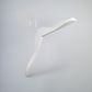 A minimalist, Rustic Motifs White Wooden Jacket Top Coat Hanger 38cm with a sleek, modern design hangs against a plain, light gray background. Ideal for wardrobe organization, this hanger features clean lines and a smooth surface, giving it an elegant and contemporary appearance.
