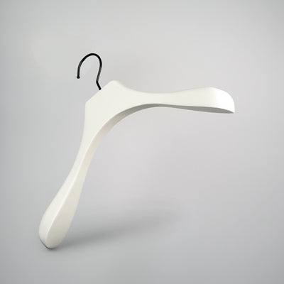 A sleek, modern White Wooden Jacket Top Coat Hanger 38cm by Rustic Motifs with a curved design and wide shoulders is depicted against a plain grey background. It features a black hook for hanging, making it perfect for use as a jacket hanger.